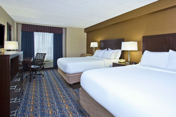 A hotel room with two beds, a desk, a chair, and a nightstand with a lamp. - Holiday Inn Express Hotel & Suites Pittsburgh West Mifflin by IHG (West Mifflin)