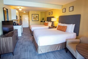 A hotel room with two beds, a desk, a TV, and a chair. - Lakeshore Inn (Lake Oswego)