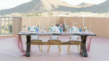 A table set outdoors with a mountain backdrop.
