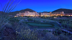 A resort with multiple buildings, a golf course, and a mountainous backdrop. - JW Marriott Starr Pass Resort and Spa (Tucson)