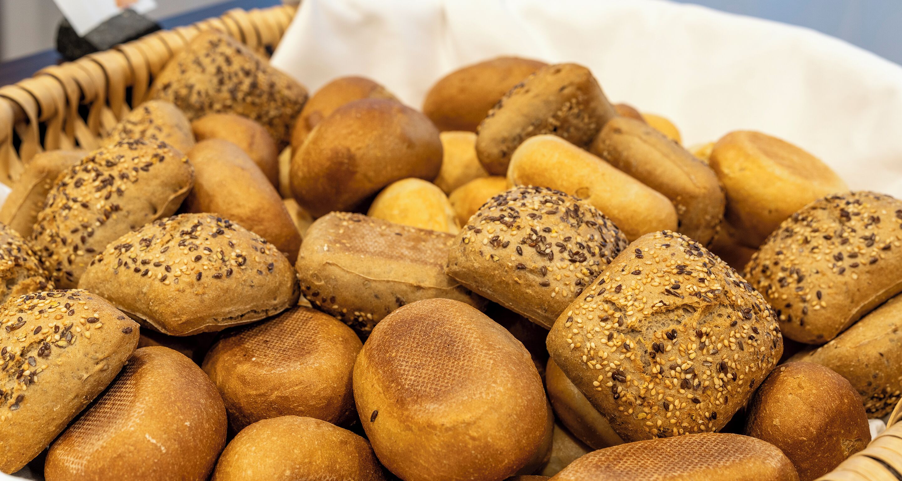 A variety of breads with different seeds and crusts.