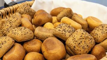 A variety of breads with different seeds and crusts.