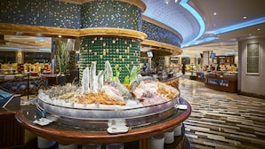 A luxurious lobby with a central ice sculpture, a high ceiling with decorative lighting, and a polished floor. - Windsor Plaza Hotel (Ho Chi Minh City)