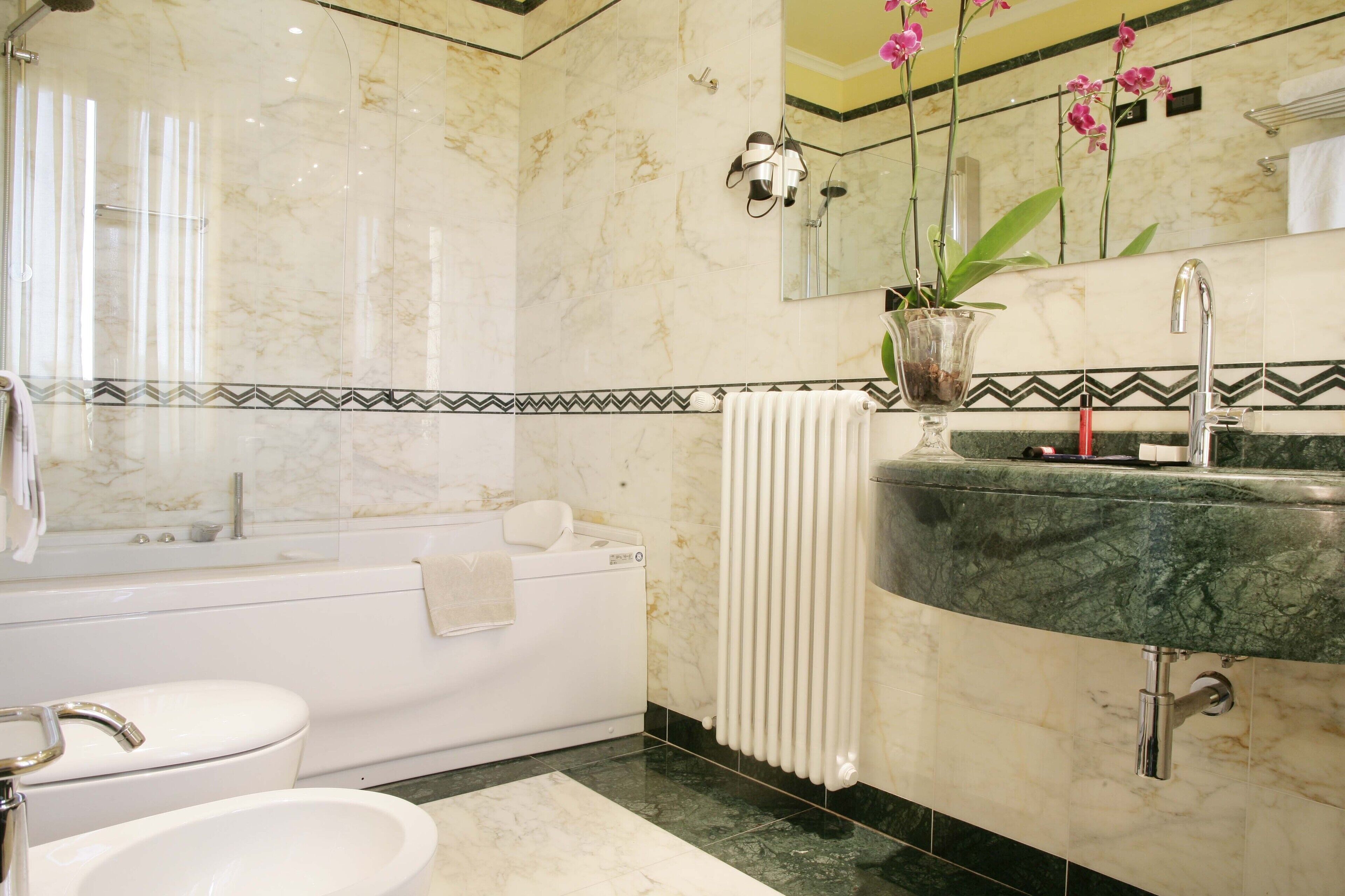 A bathroom with a bathtub, a sink, and a toilet.