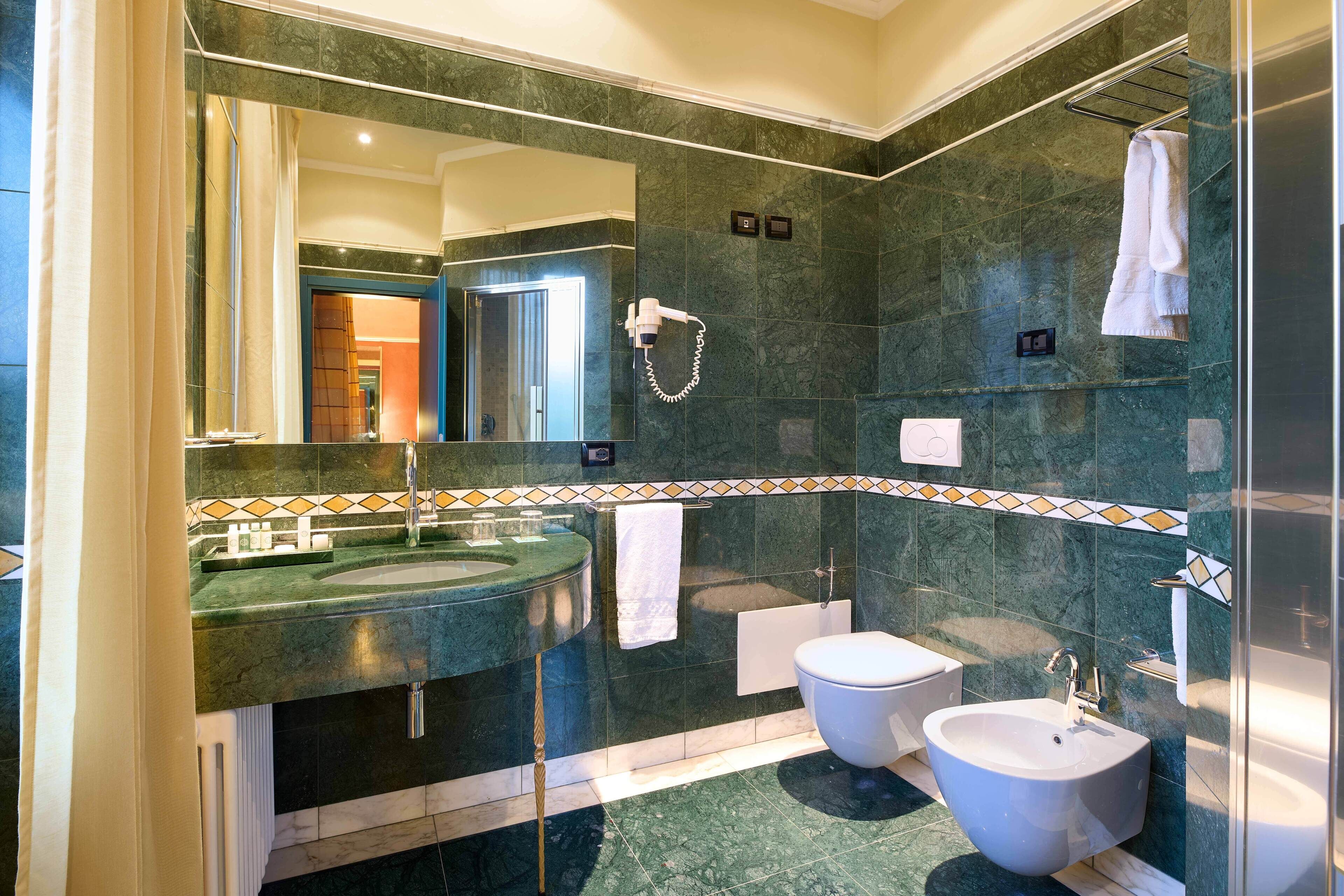 luxury room | bathroom | hair dryer, slippers, bidet, towels