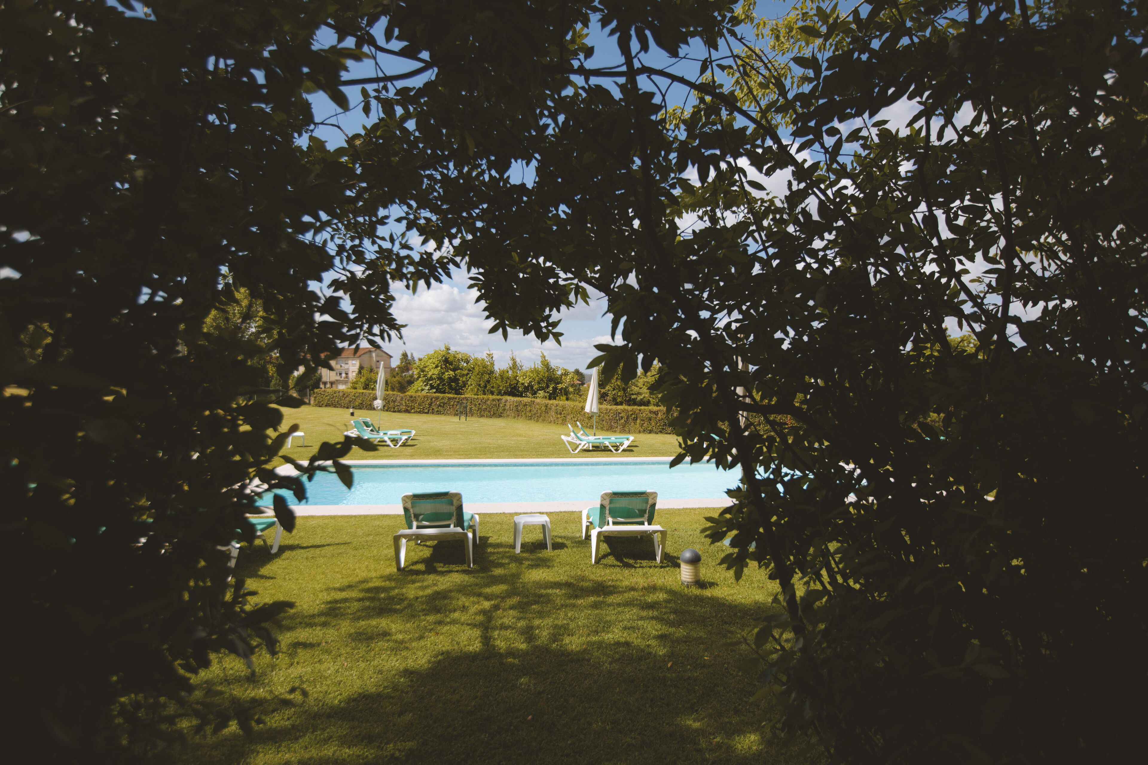 A pool area with lounge chairs and a clear view of the pool.