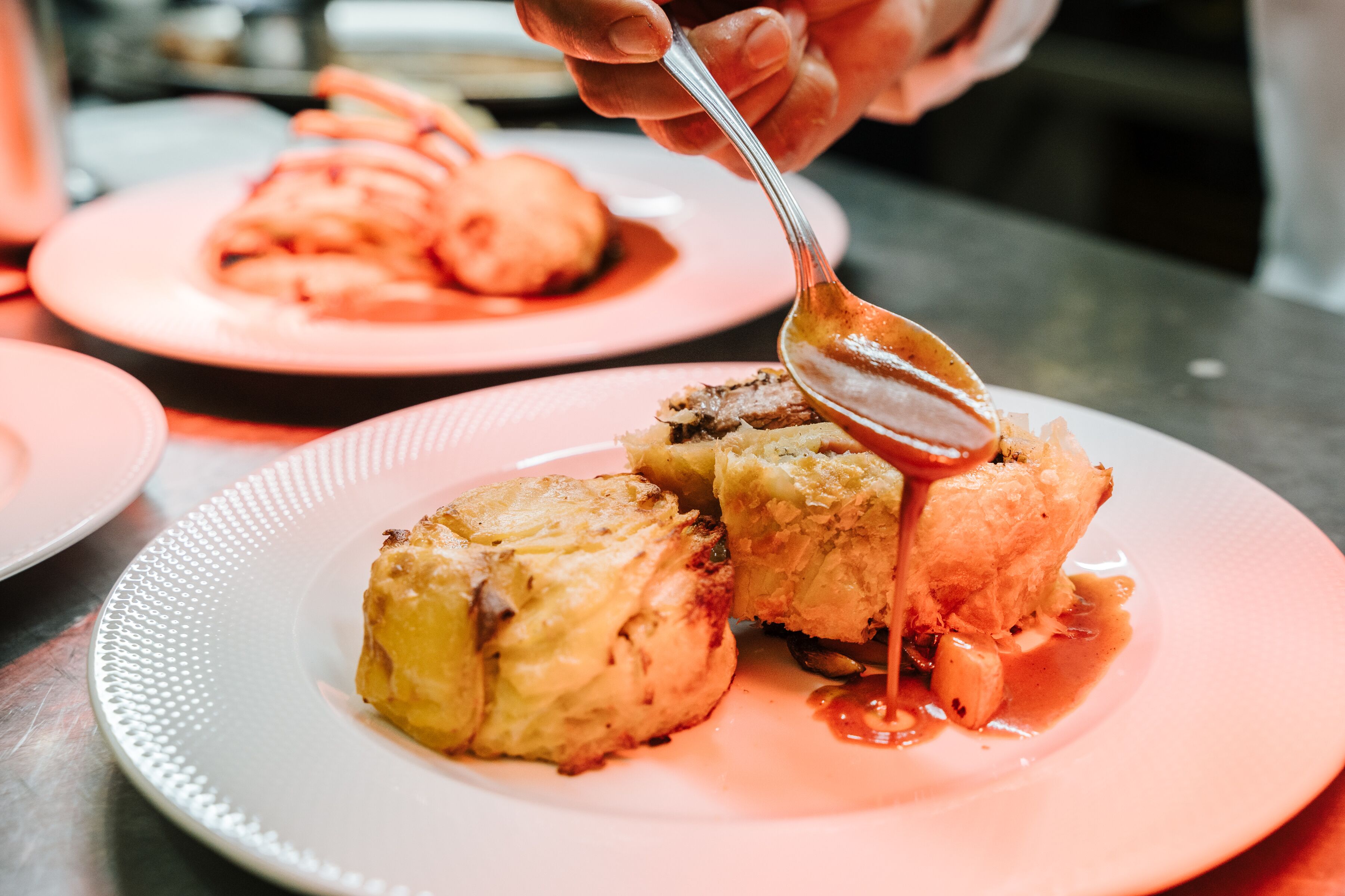 A dessert with a spoonful of sauce on a plate.