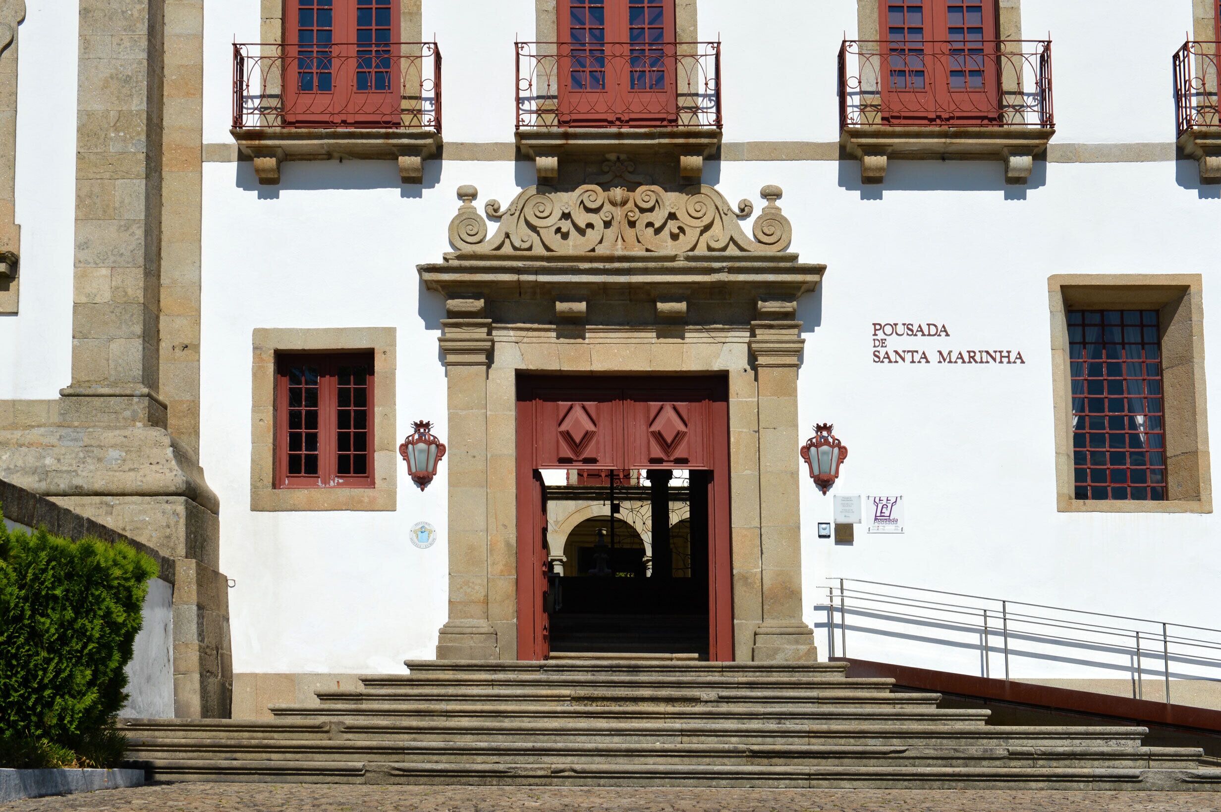 A building with a central entrance, steps leading up to it, and a sign reading "Pousada de Santa Marinha".