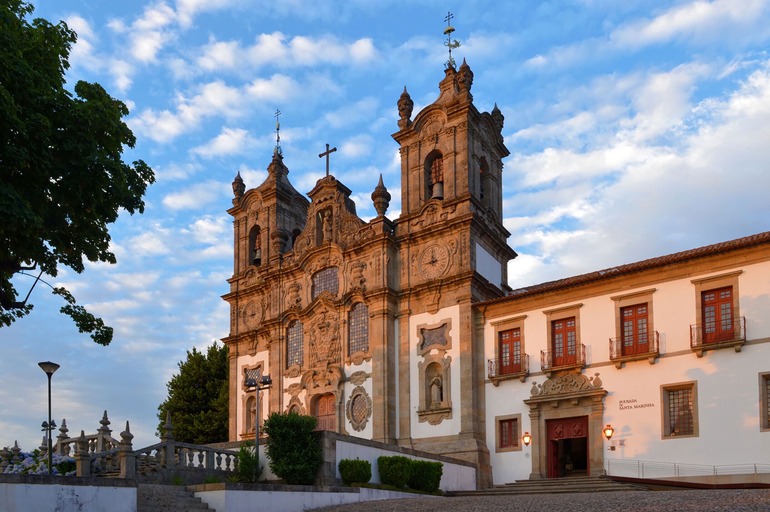A historic church with ornate architecture, including multiple bell towers and a prominent clock.