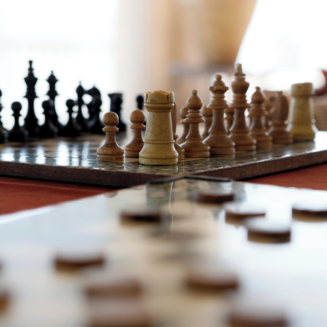 A chessboard with pieces in focus, and a blurred background.