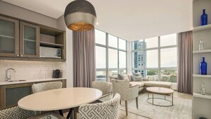 A modern kitchen with a dining area, large windows, and a city view. - Protea Hotel by Marriott Durban Umhlanga (Umhlanga)