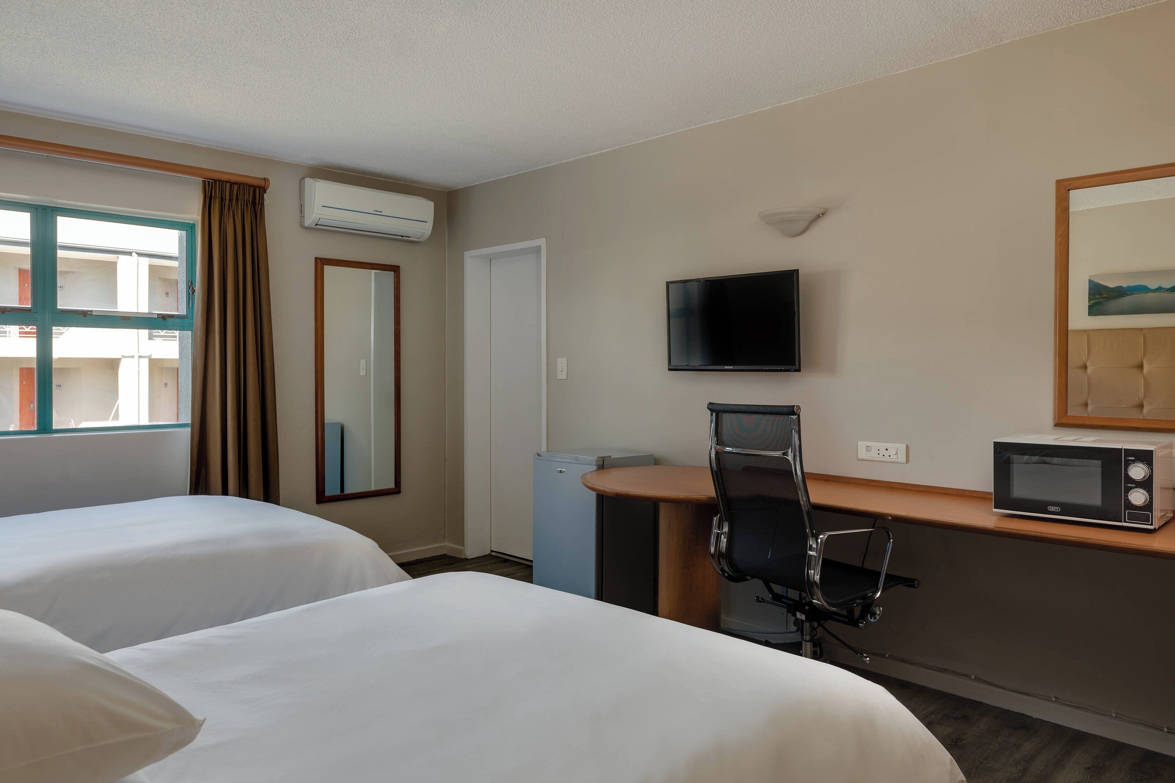 room, 2 double beds, non smoking, garden view | minibar, in-room safe, desk, iron/ironing board