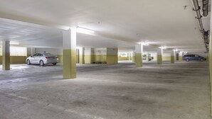 A multi-level parking garage with concrete floors and yellow pillars. - Holiday Inn Express Hotel & Suites White River Junction by IHG (White River Junction)