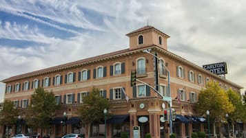 Experience the classic charm of The Carlton Hotel, situated at a prominent street corner with a restaurant on the ground floor.