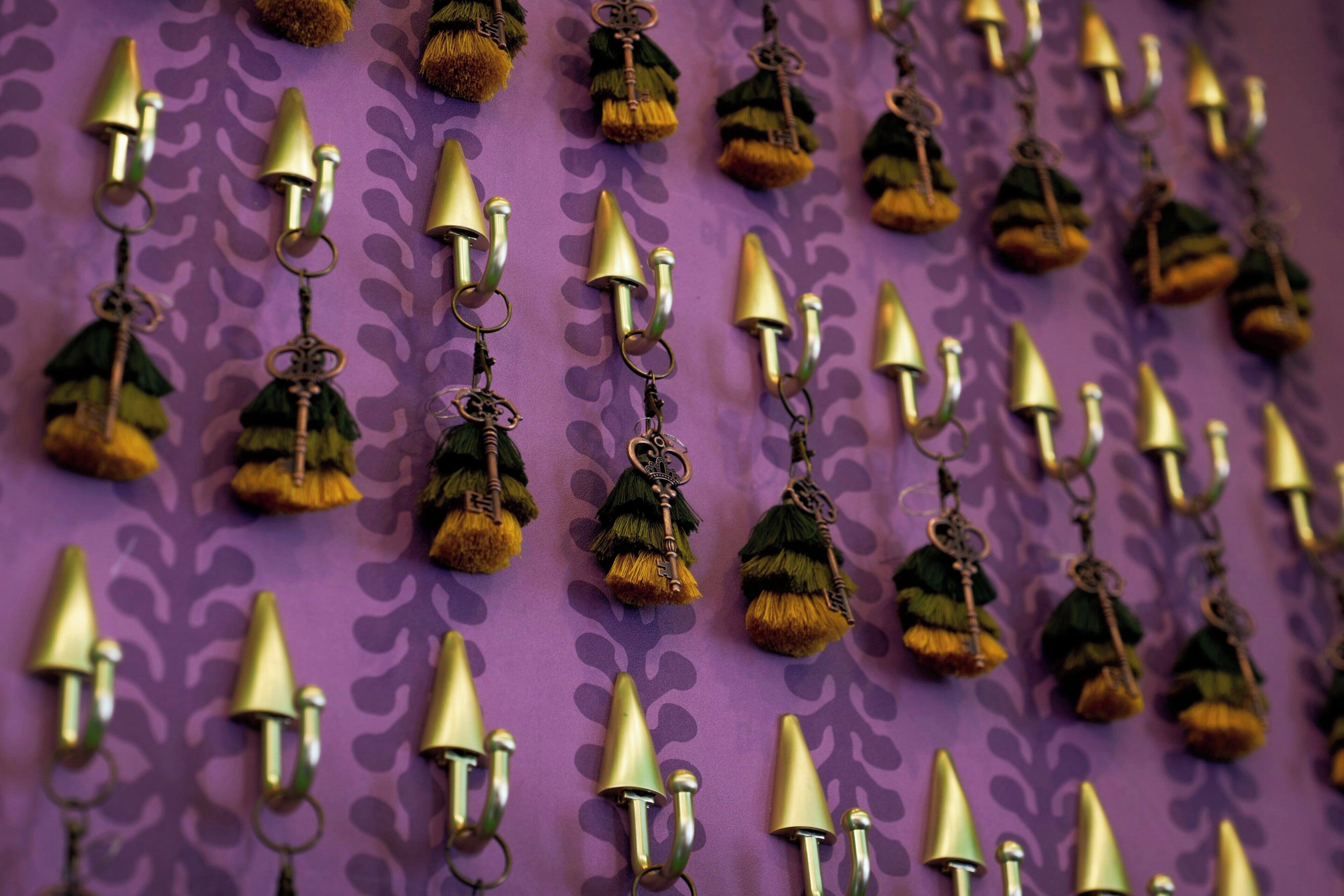A wall with multiple hanging keychains.