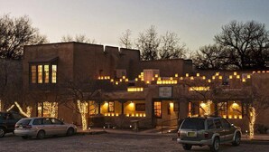 A building with multiple windows and a sign that reads "The Abc Hotel".