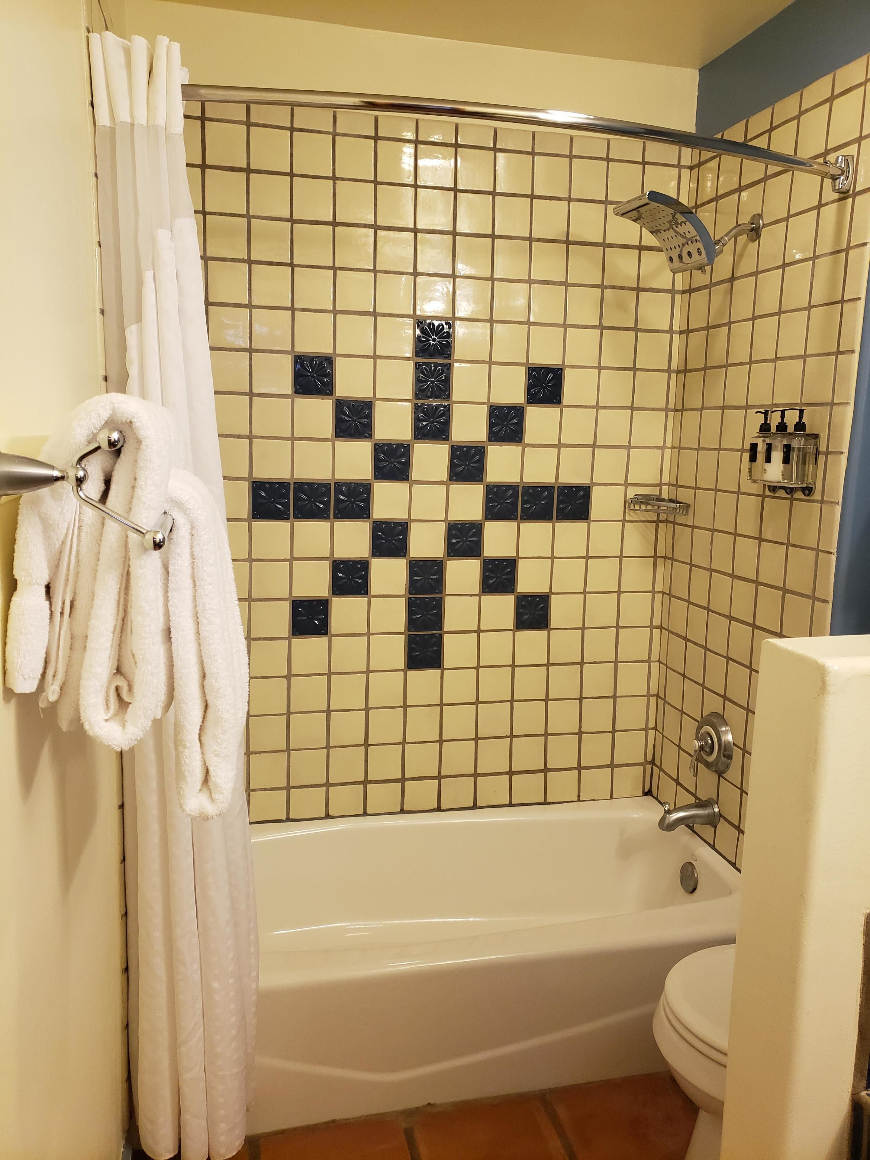 A bathroom with a bathtub, a shower, and a toilet.