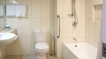 A modern bathroom with a toilet, sink, shower, and bathtub.