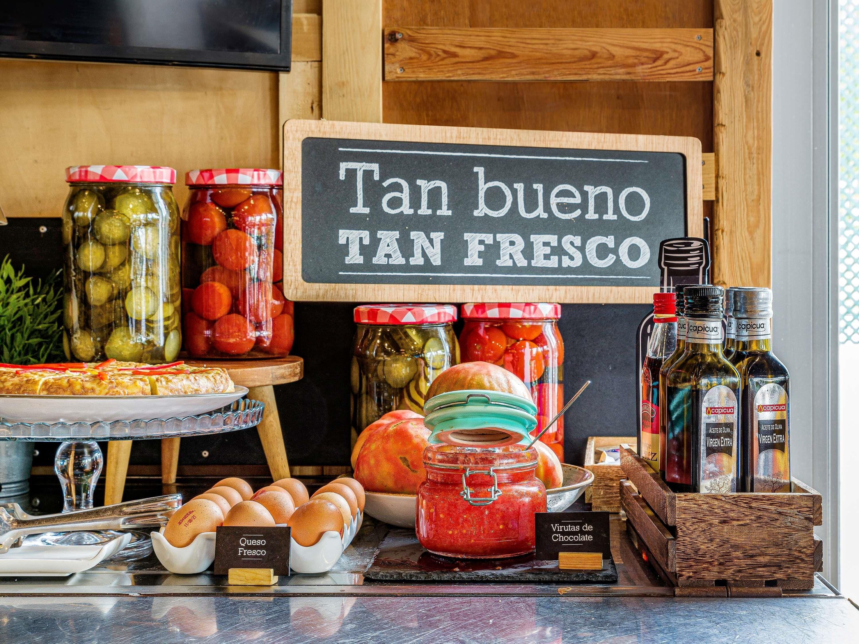 A breakfast buffet with various food items and condiments.