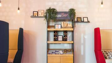 A bar area with a sign reading "Bar", shelves with bottles and a sign that says "ONWARD UPWARD", and two chairs with cushions.