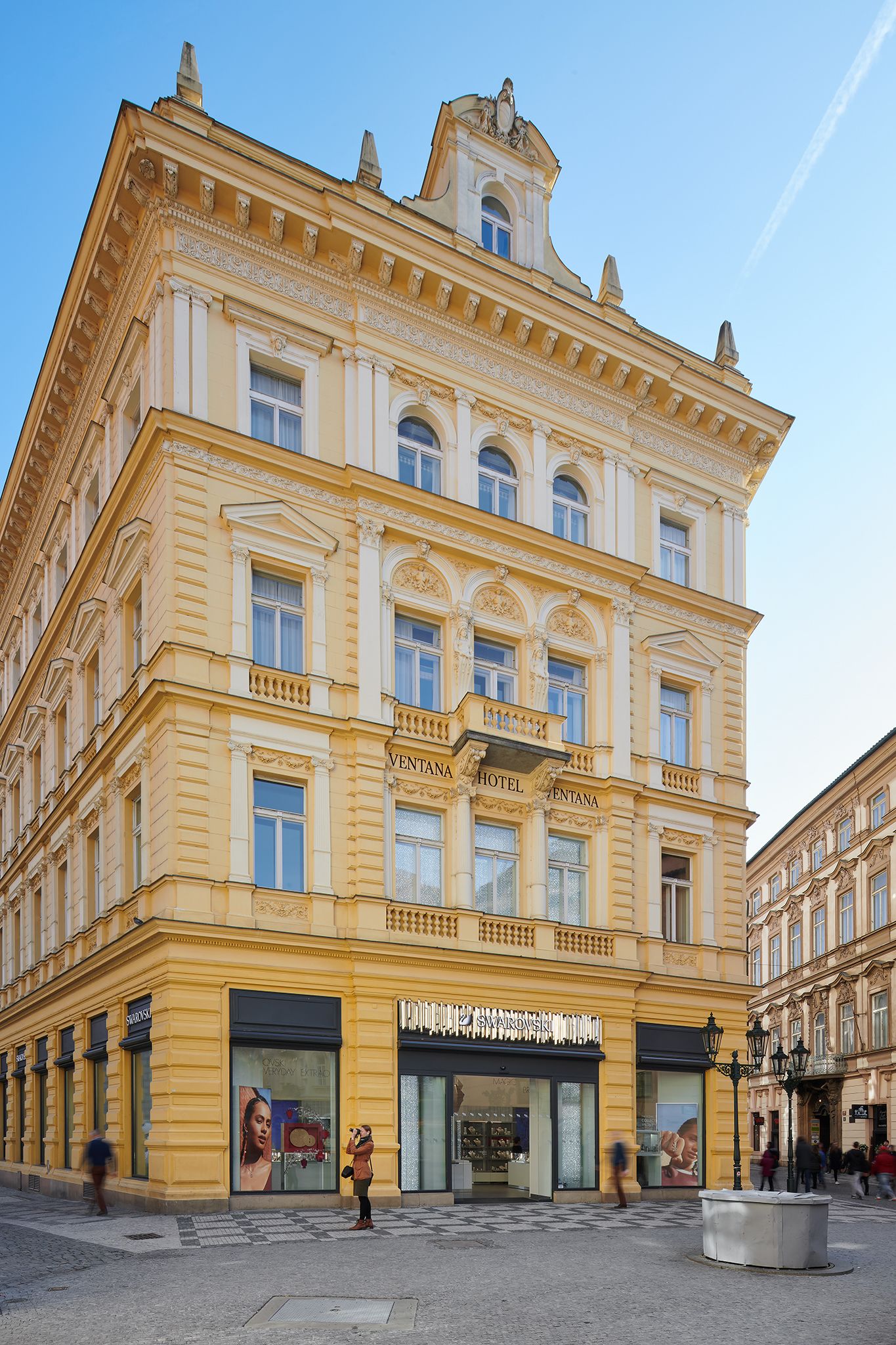 A historic building with a prominent "VENTANA HOTEL" sign. It features classical architecture with ornate detailing and large windows.