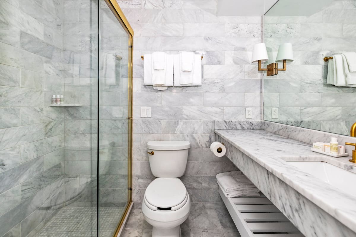 combined shower/bathtub, designer toiletries, hair dryer, bathrobes