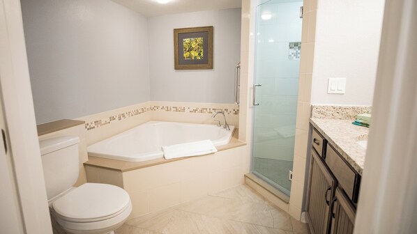 A bathroom with a bathtub, toilet, and a shower area. - Holiday Inn Club Vacations Cape Canaveral Beach Resort by IHG (Cape Canaveral)