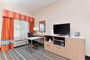 A hotel room with a bed, a desk, a television, a microwave, and a window with curtains. - Holiday Inn Express Bernalillo by IHG (Bernalillo)