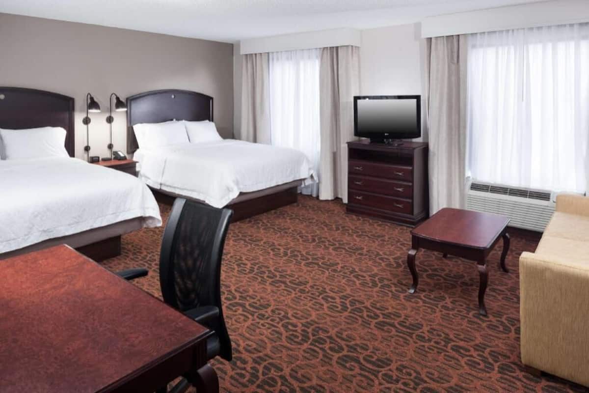 Premium bedding, desk, laptop workspace, blackout drapes