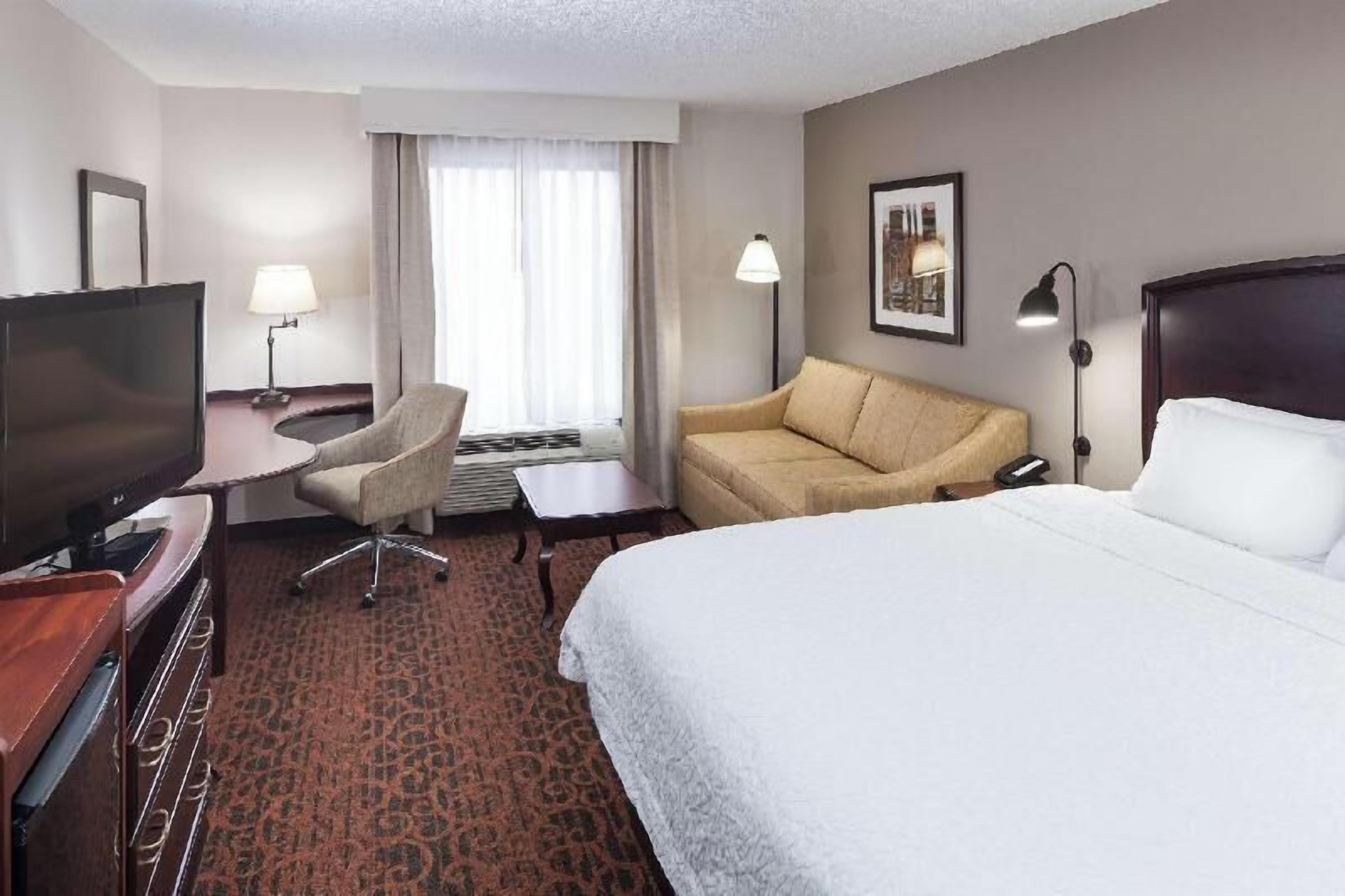 Premium bedding, desk, laptop workspace, blackout drapes