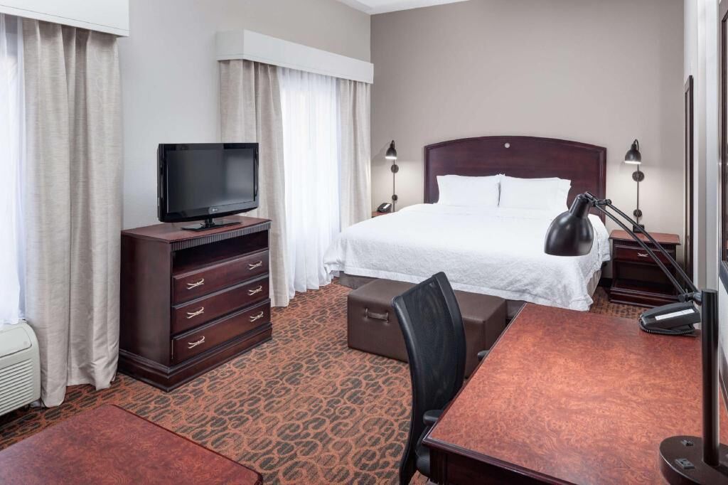 Premium bedding, desk, laptop workspace, blackout drapes
