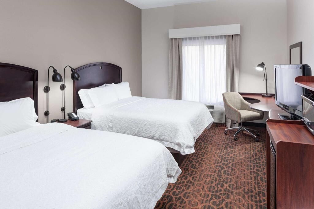 Premium bedding, desk, laptop workspace, blackout drapes