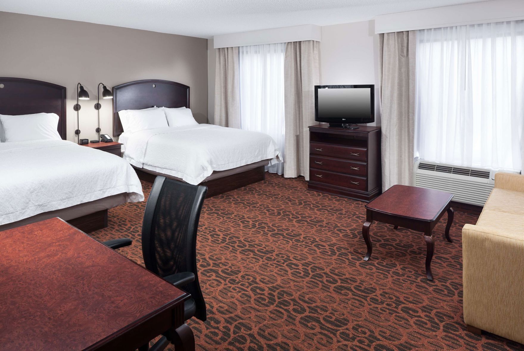 Premium bedding, desk, laptop workspace, blackout drapes