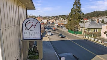 A Heritage Inn sign with a view of a street and surrounding buildings.