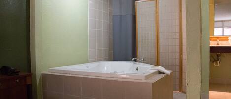 A bathroom with a bathtub, a shower, and a toilet.