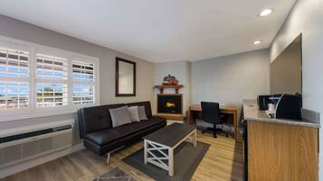 Suite, 1 King Bed, Non Smoking | Desk, laptop workspace, blackout drapes, iron/ironing board