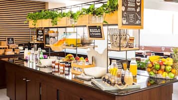 Enjoy a fresh start with a well-stocked breakfast bar featuring a variety of fruits, juices, and spreads.