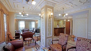 A spacious lobby with leather sofas, patterned armchairs, and a reception desk. - Sumengen Hotel (Istanbul)