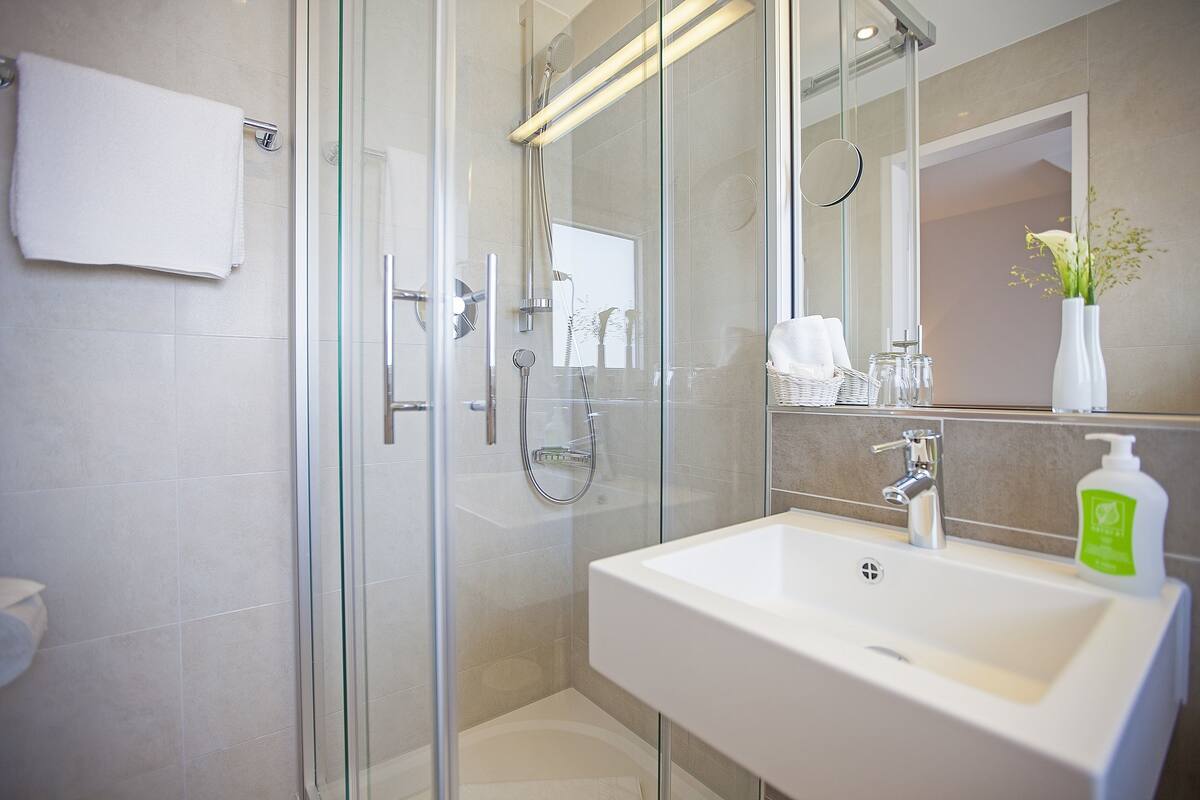 double room single use | bathroom | shower, hair dryer, bathrobes, towels