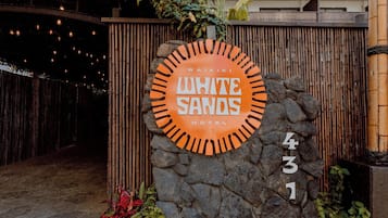 A hotel sign with the name 'White Sands Hotel' and the address '431'.