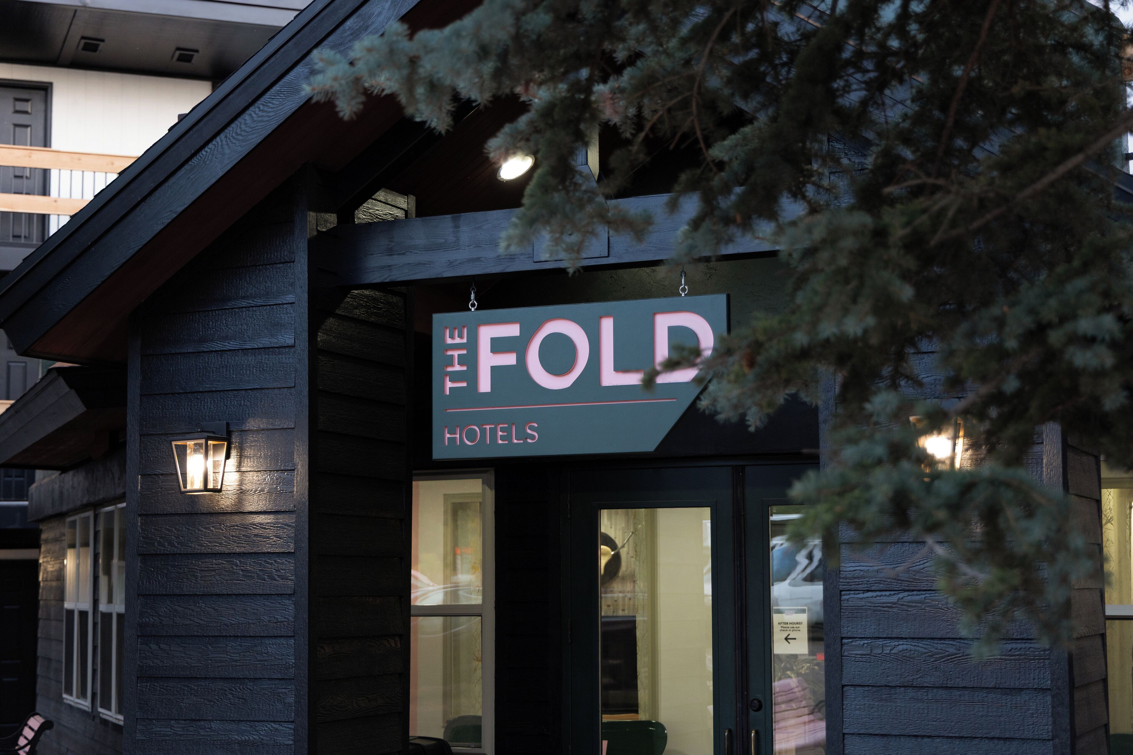A hotel sign with the name "The Fold Hotels" and a visible entrance door.