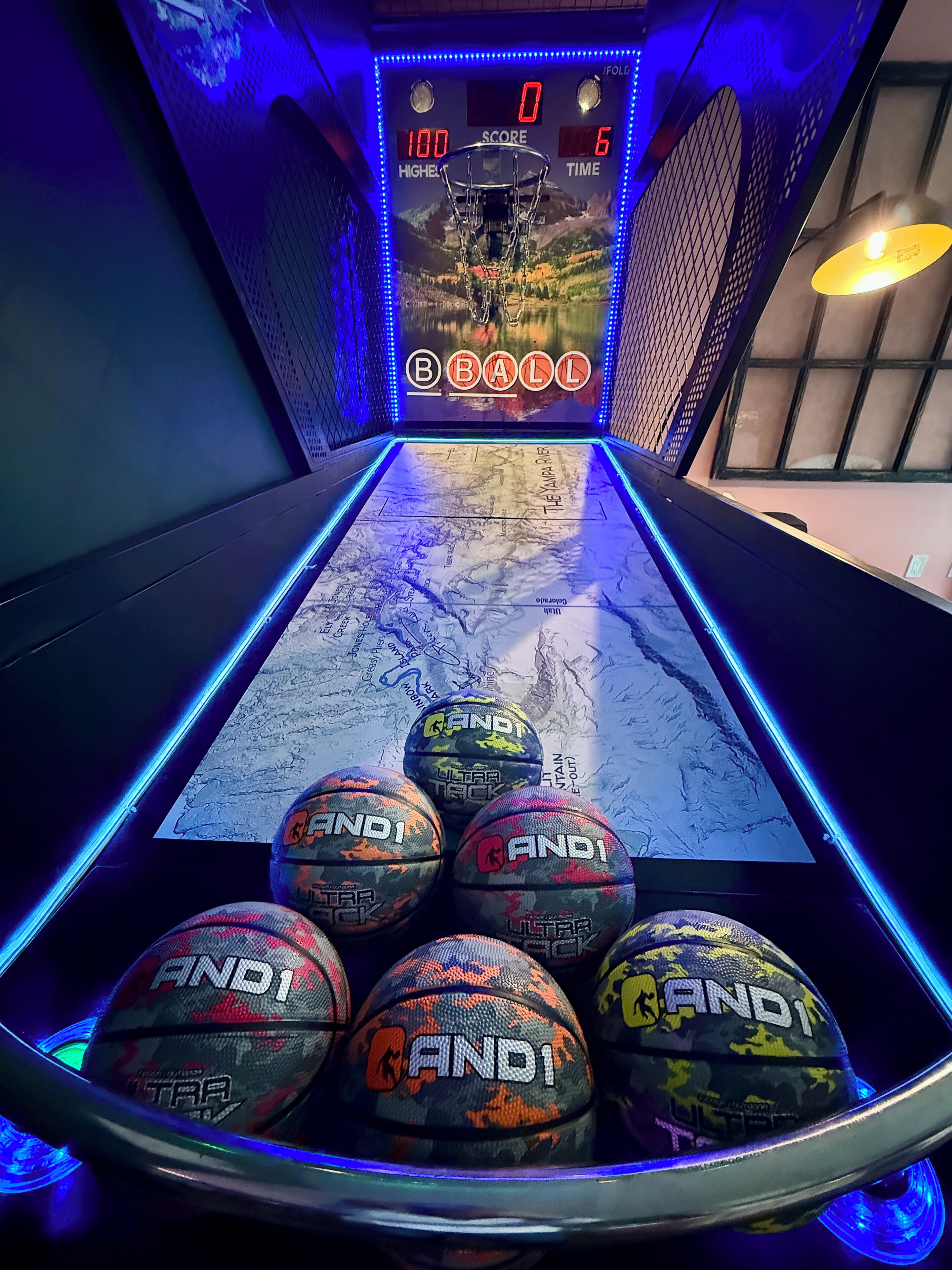 A pool table with six billiard balls and a scoreboard.