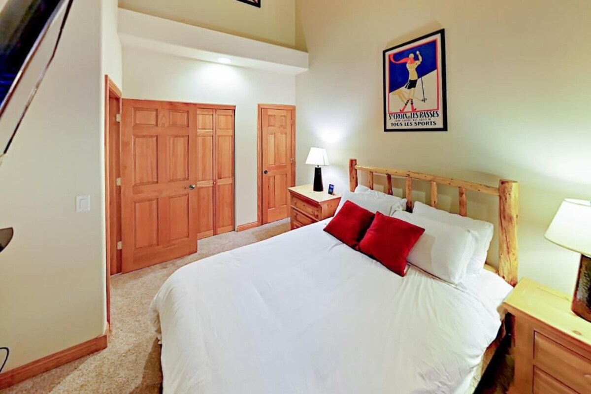 Una camera da letto con un letto grande, un'armadio in legno e un quadro appeso al muro.