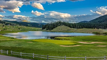 Surrounded by lush greenery and rolling hills, this golf course offers a serene escape with a picturesque lake and varied terrain for golfing and nature exploration.