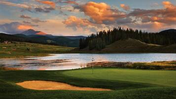 Enjoy a serene golf experience with a well-maintained fairway, sand bunker, and picturesque lake views.