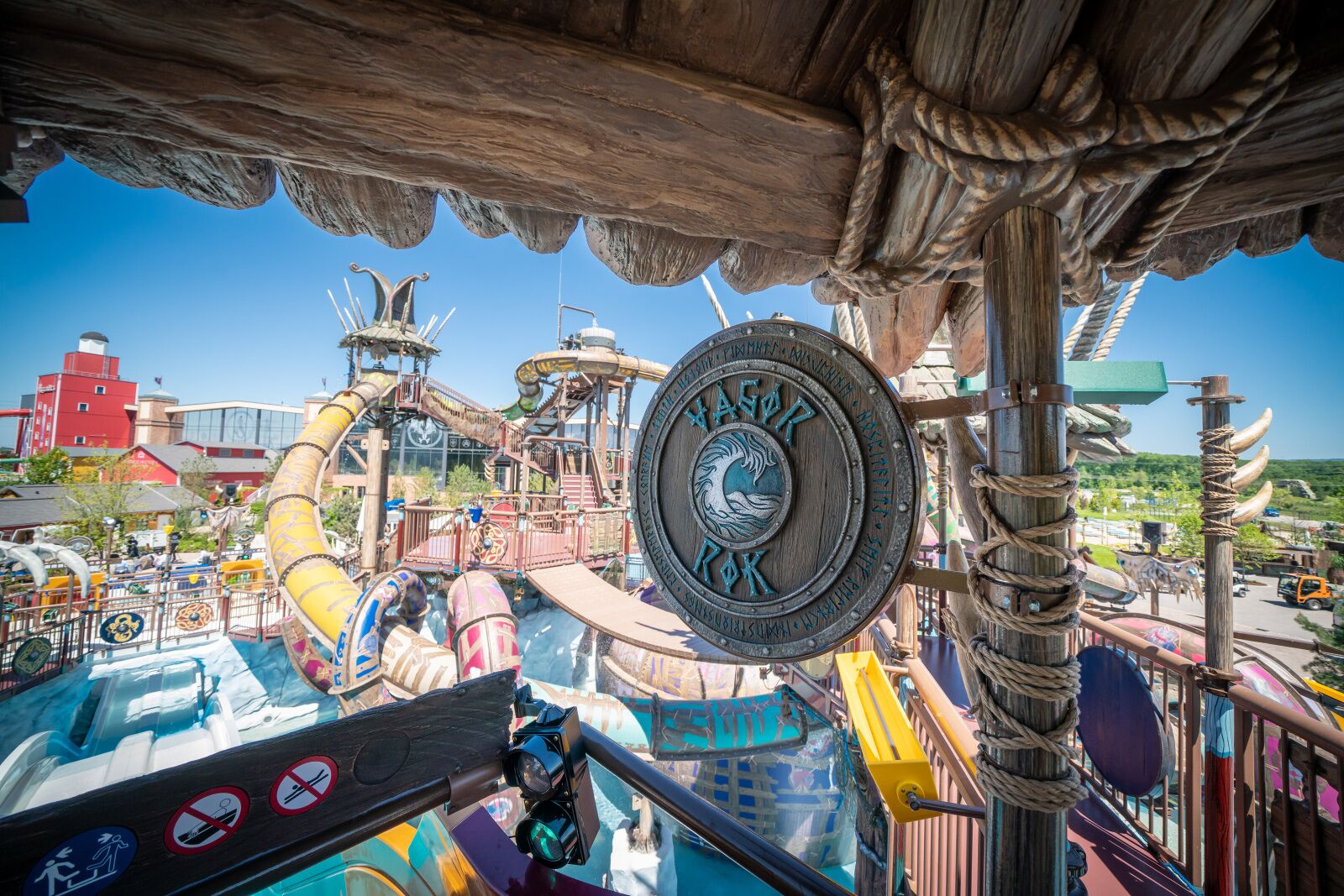 A Viking-themed amusement park ride with a wooden ship structure, a steering wheel, and a large emblem with the text "VAGOR ROK".