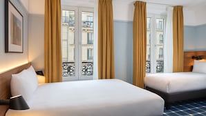 A hotel room with two beds, large windows with curtains, a framed picture on the wall, and a checkered floor. - Timhotel Paris Gare du Nord (Paris)