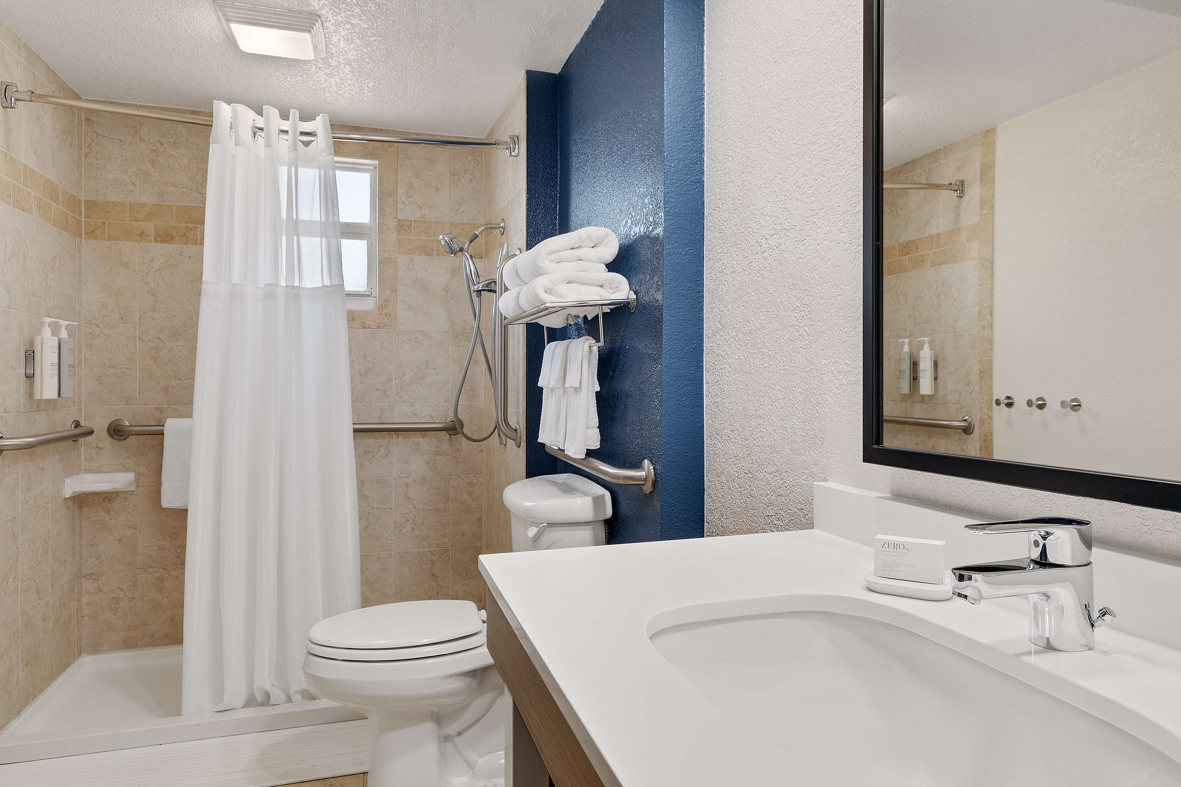 Un baño moderno con ducha, inodoro y lavabo.