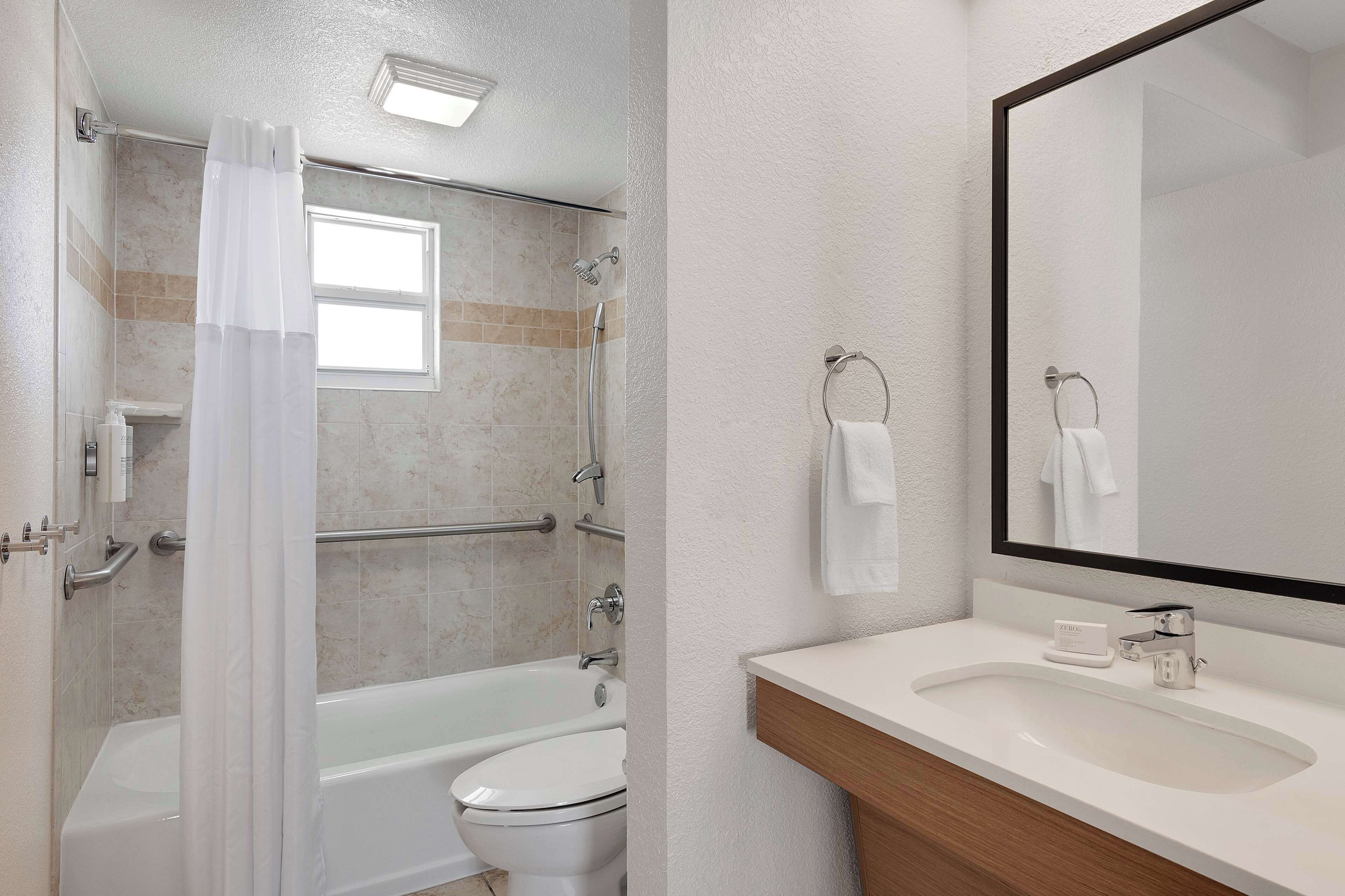 A bathroom with a bathtub, toilet, and sink.
