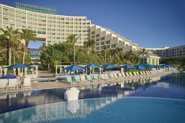 Experience the hotel's contemporary design and relax by the pool surrounded by palm trees.